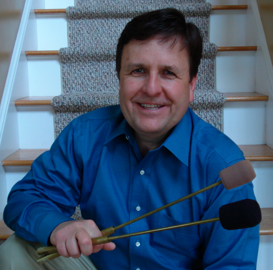 Dr. Boulanger sitting on stairs with Radio Batons